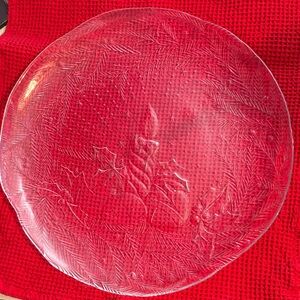 Clear Glass Holiday Plate with candle and ornaments And Holly leaves